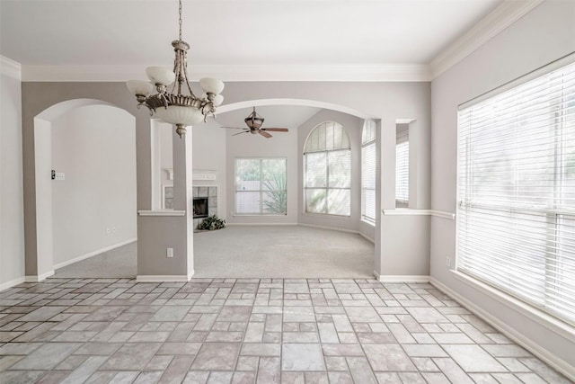 unfurnished living room with ornamental molding, a fireplace, ceiling fan with notable chandelier, and light carpet