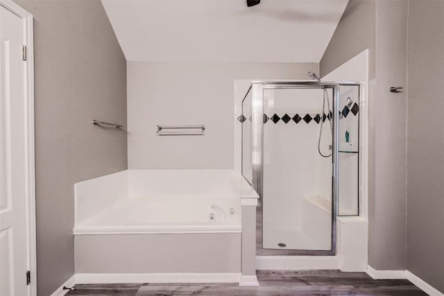 6 Muirfield Greens Cv, Lakeway, TX 78738 - bathroom with a garden tub, wood finished floors, a stall shower, lofted ceiling, and baseboards