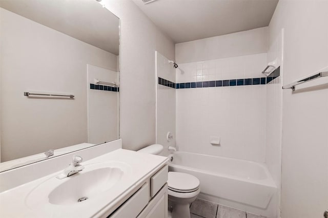 full bathroom with tiled shower / bath, vanity, tile patterned floors, and toilet