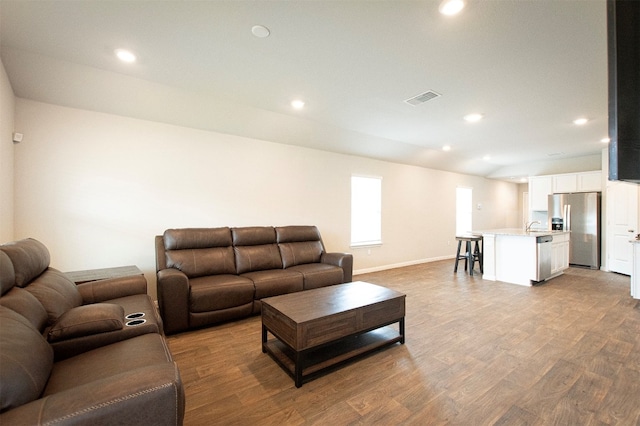 living room featuring sink and light wood-type flooring