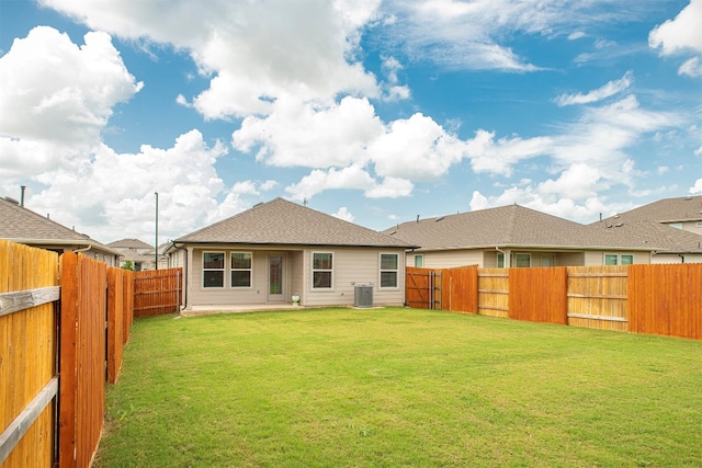 back of house with a lawn