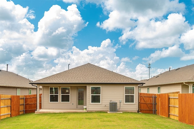 back of property with a patio area, cooling unit, and a yard