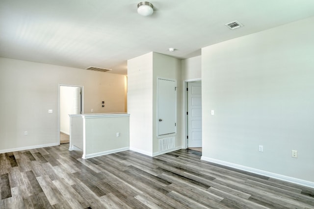 unfurnished room with hardwood / wood-style flooring