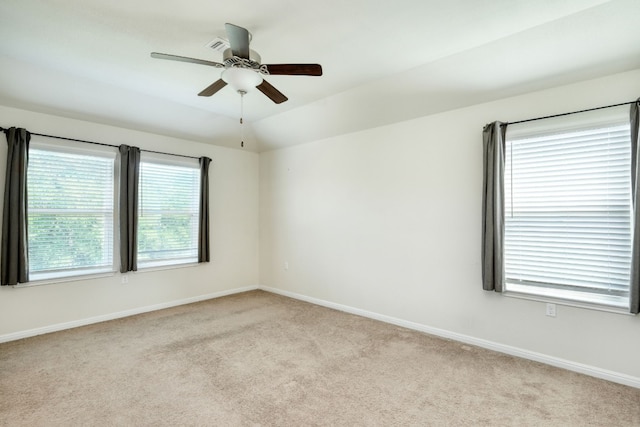 carpeted empty room with ceiling fan and vaulted ceiling