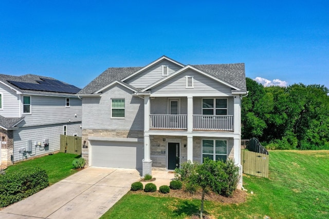 view of front of home with solar panels, a balcony, a garage, and a front lawn