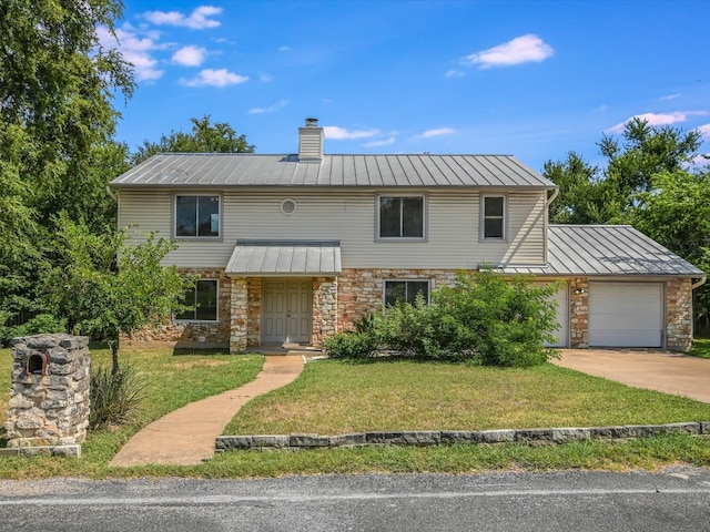 view of front of house featuring a garage and a front lawn