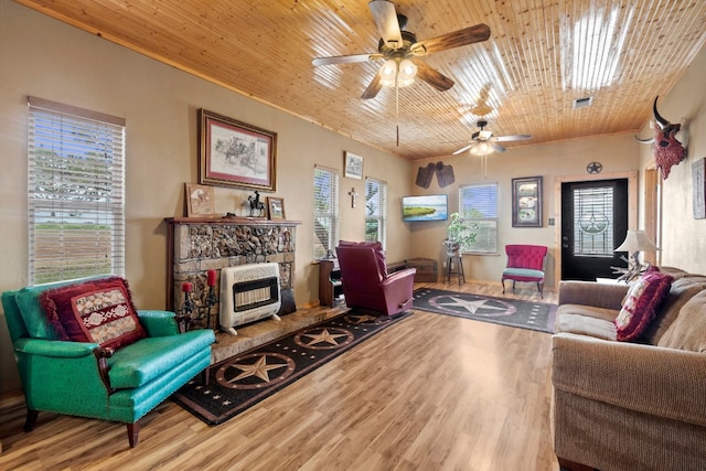 living room with a fireplace, light hardwood / wood-style floors, wood ceiling, and ceiling fan