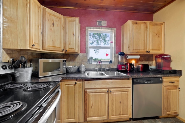 kitchen with sink, light brown cabinetry, backsplash, and stainless steel appliances