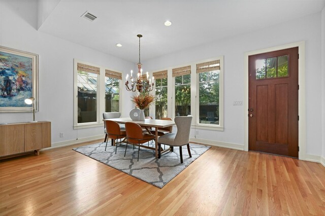 dining space featuring an inviting chandelier, light hardwood / wood-style flooring, and a wealth of natural light