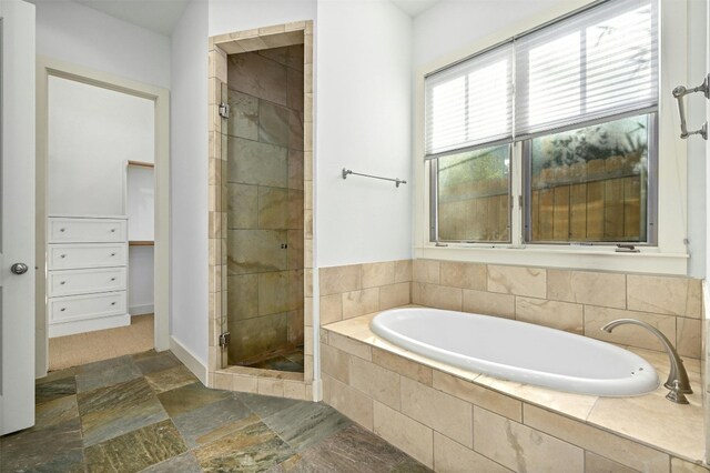 bathroom featuring separate shower and tub