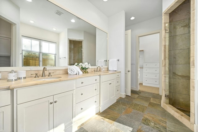 bathroom featuring vanity and a shower with door