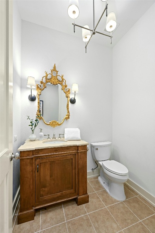 bathroom with vanity, toilet, and tile patterned floors