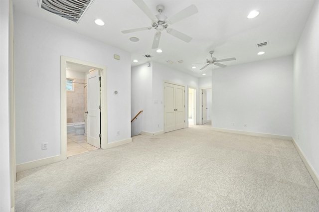 unfurnished room with ceiling fan and light colored carpet