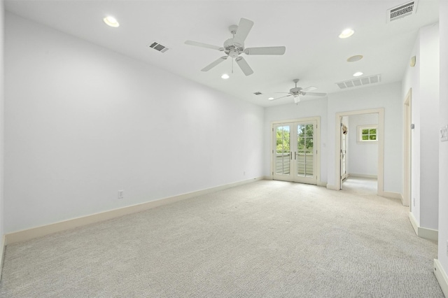 carpeted spare room featuring ceiling fan