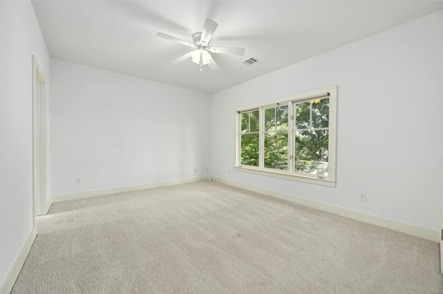 carpeted spare room with ceiling fan