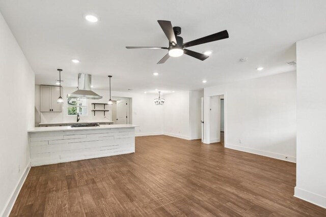 unfurnished living room featuring ceiling fan and wood-type flooring