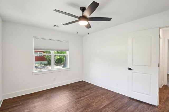 empty room featuring ceiling fan and dark hardwood / wood-style flooring