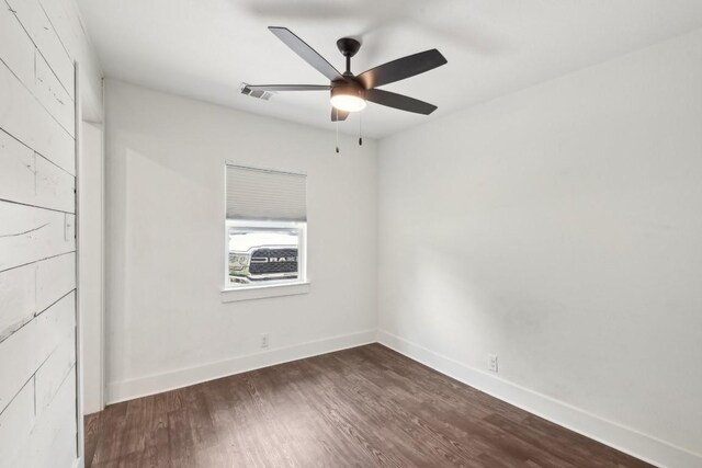 empty room with hardwood / wood-style floors and ceiling fan