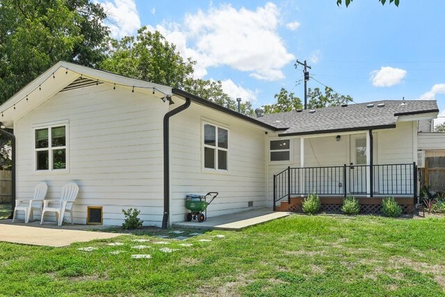 rear view of property with a lawn