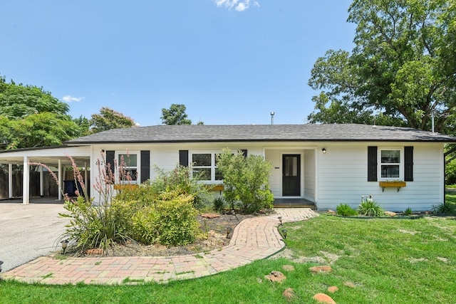 ranch-style house with a carport and a front lawn