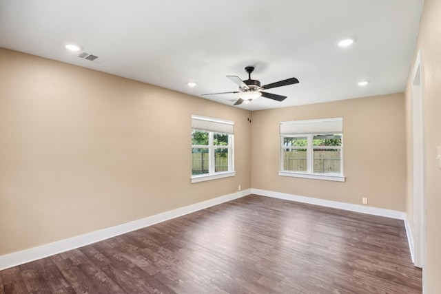 spare room with dark hardwood / wood-style floors and ceiling fan