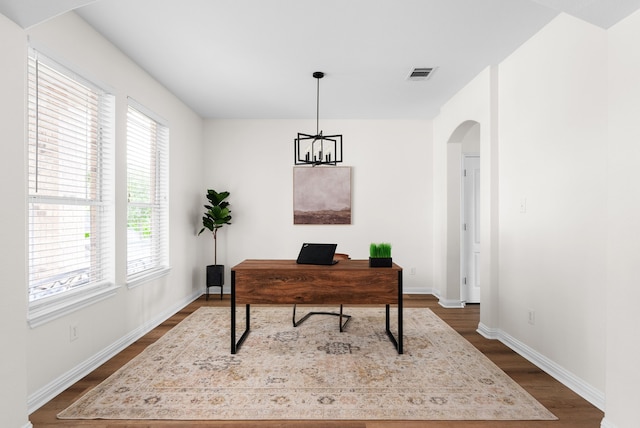 office featuring dark hardwood / wood-style flooring and a notable chandelier