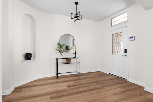 foyer featuring hardwood / wood-style flooring and a chandelier