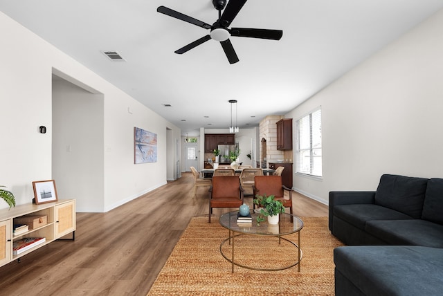 living room with hardwood / wood-style flooring and ceiling fan