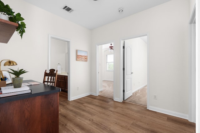 office area with ceiling fan and hardwood / wood-style floors