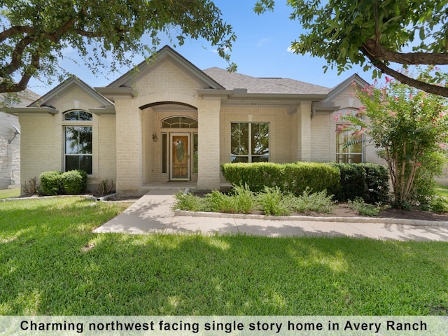 ranch-style home featuring a front yard