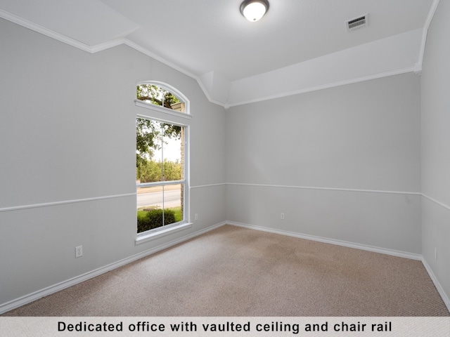 spare room with carpet, crown molding, and vaulted ceiling