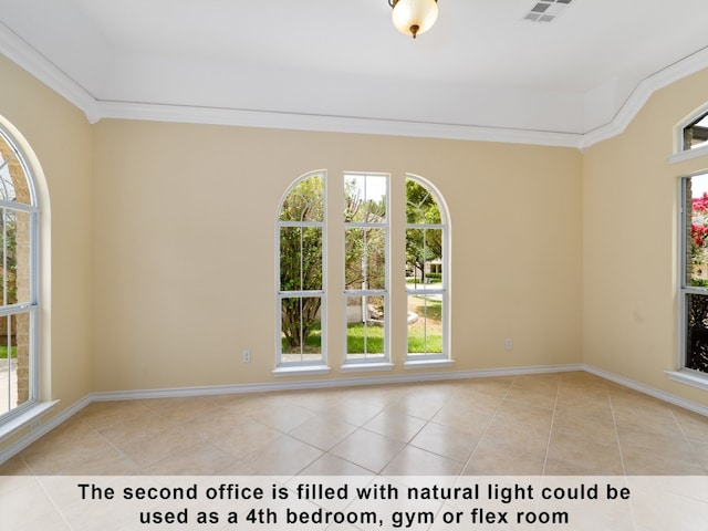 tiled empty room featuring crown molding