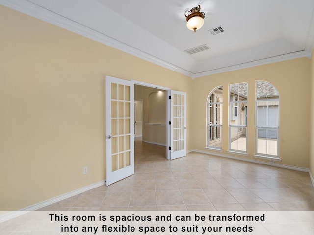 spare room with crown molding, french doors, and light tile patterned floors