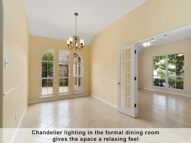 interior space with an inviting chandelier, lofted ceiling, light tile patterned floors, and plenty of natural light