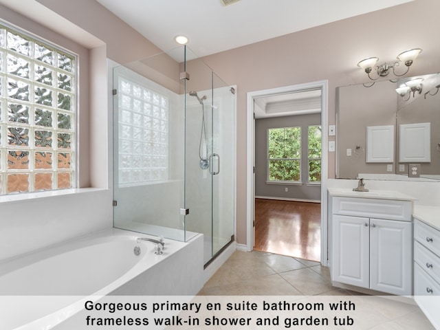 bathroom with vanity, wood-type flooring, and separate shower and tub