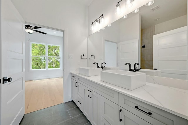 bathroom featuring double vanity, tile patterned flooring, and ceiling fan