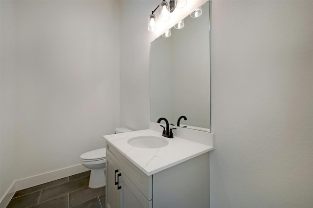 bathroom featuring tile patterned floors, vanity, and toilet