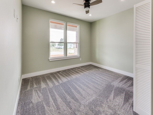 spare room with carpet flooring and ceiling fan