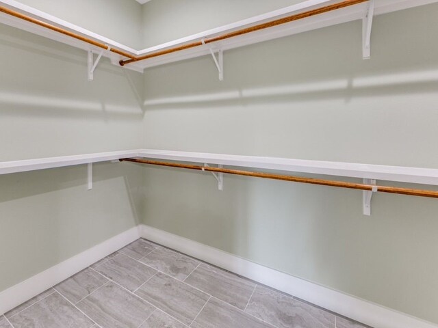 spacious closet featuring light tile patterned flooring