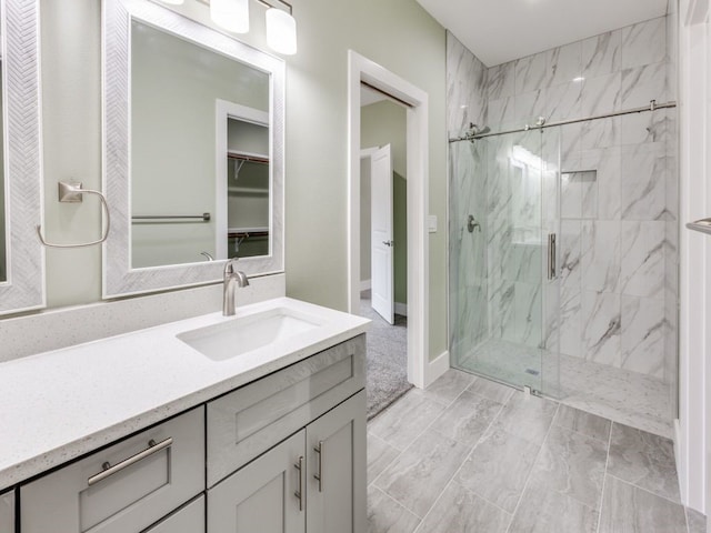 bathroom featuring vanity and an enclosed shower