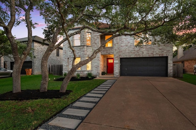 view of front facade featuring a garage and a lawn