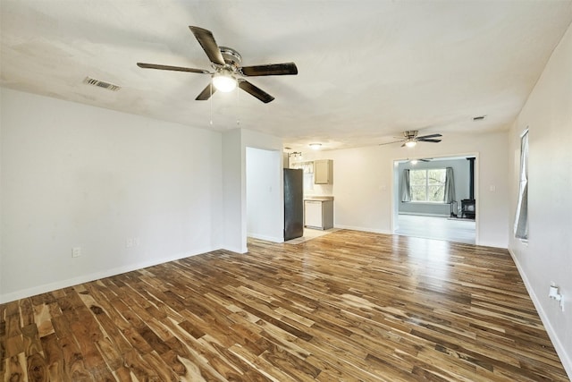 unfurnished living room with ceiling fan and hardwood / wood-style floors