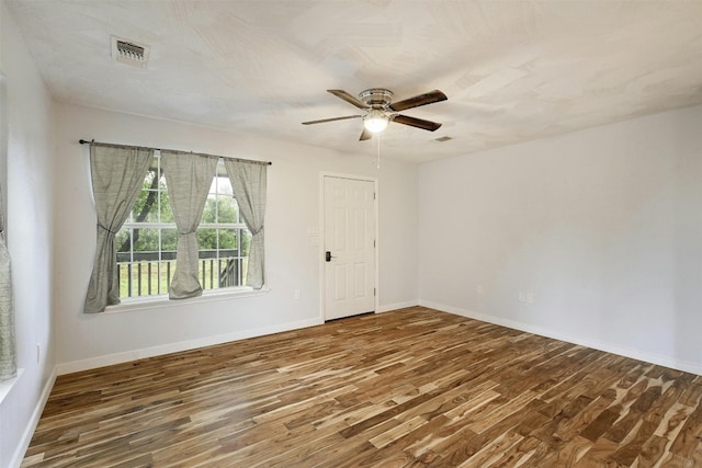 unfurnished room featuring ceiling fan and dark hardwood / wood-style floors