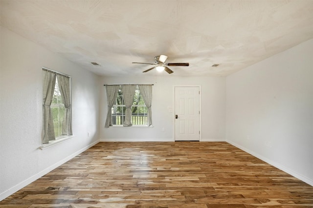 unfurnished room with wood-type flooring and ceiling fan