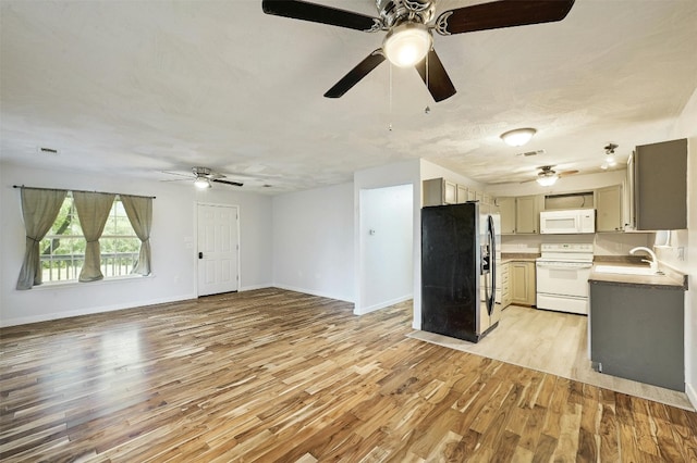 kitchen featuring light hardwood / wood-style floors, gray cabinetry, sink, and white appliances