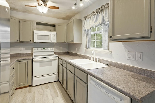 kitchen with white appliances, light hardwood / wood-style floors, sink, and ceiling fan