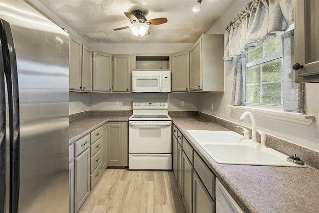 kitchen with ceiling fan, sink, light wood-type flooring, and white appliances