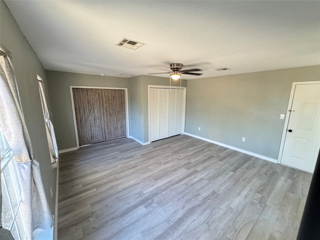 unfurnished bedroom featuring light hardwood / wood-style flooring and ceiling fan