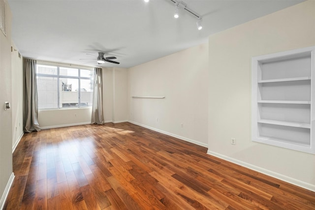 empty room with hardwood / wood-style floors, track lighting, and ceiling fan