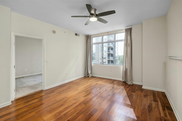 spare room featuring hardwood / wood-style flooring and ceiling fan